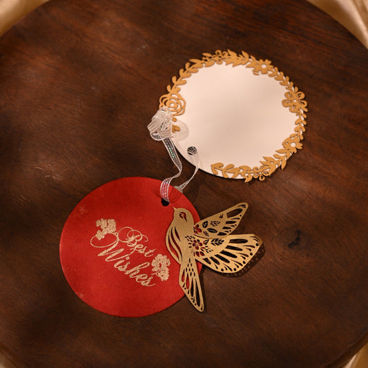 Layered red gift tags with gold 'Best Wishes' text and gold bird cut-outs, in laser cut detailing
