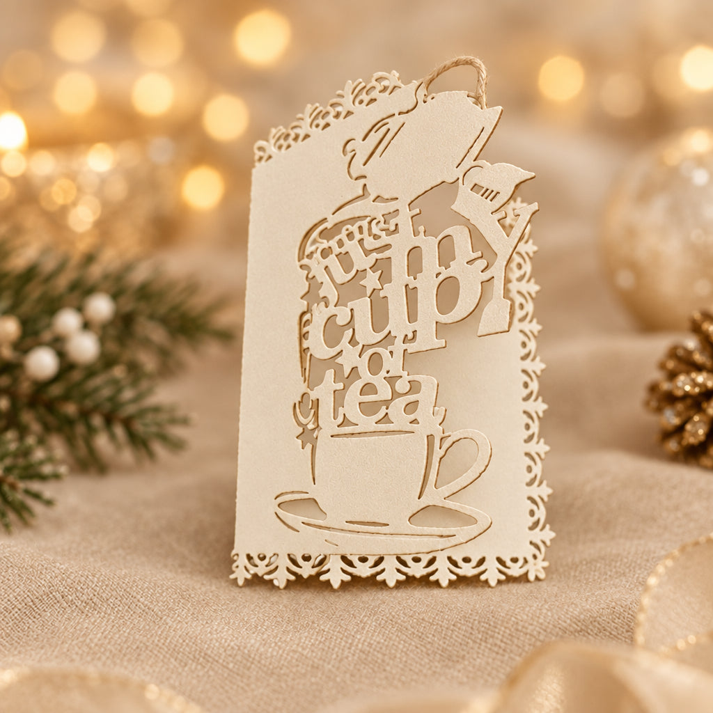 Decorative white gift tags with laser-cutwork, featuring a teapot, teacup and saucer, writing