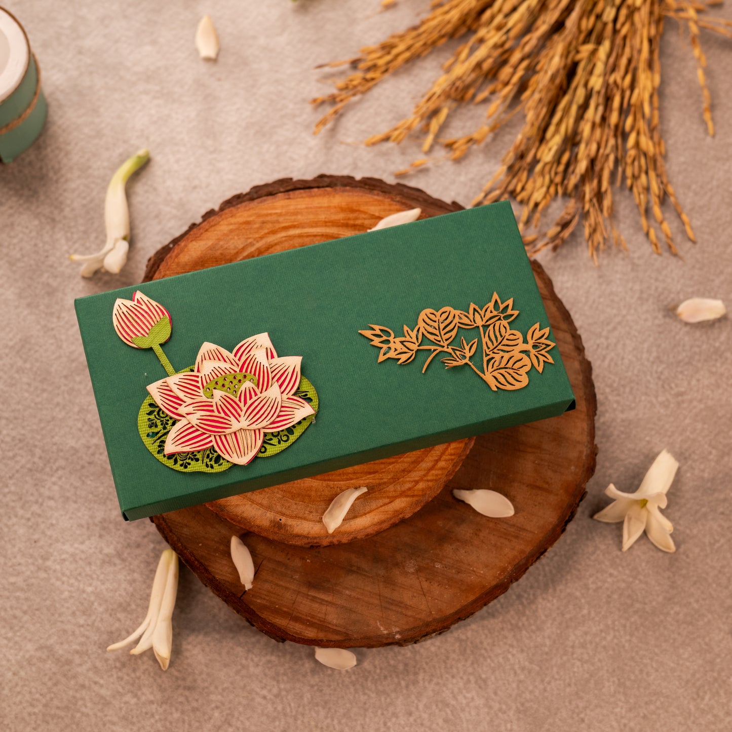 A green soft cash box with a 3D lotus design one side and flower motifs on the other