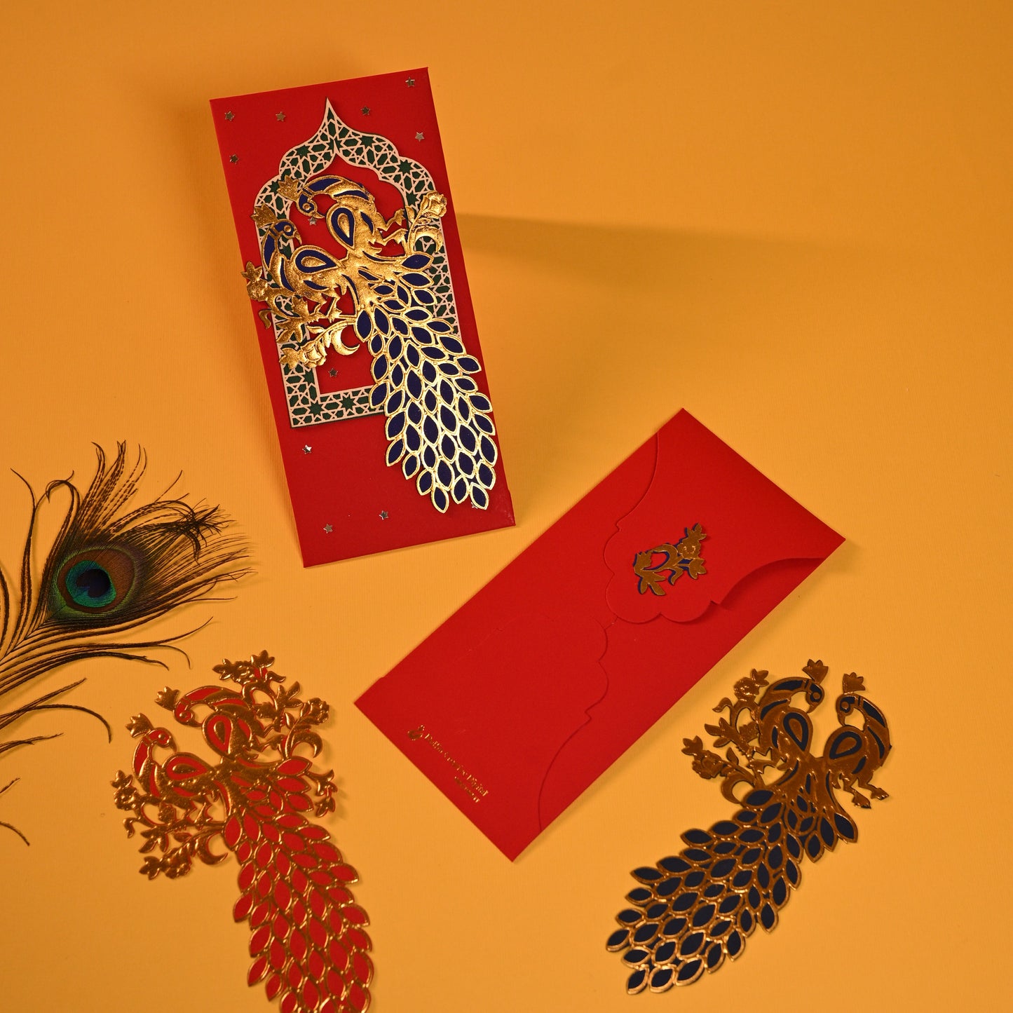 Red envelopes with intricate designs of peacock gold foil work