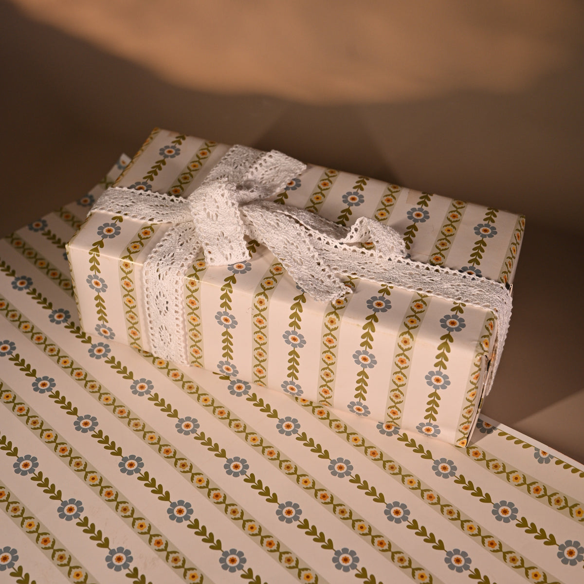 This reversible wrapping paper having two distinct vibes—the bold, energetic orange and pink blooms on one side and the clean, white minimal design on the other—makes it such a versatile staple for a gift-wrap stash.