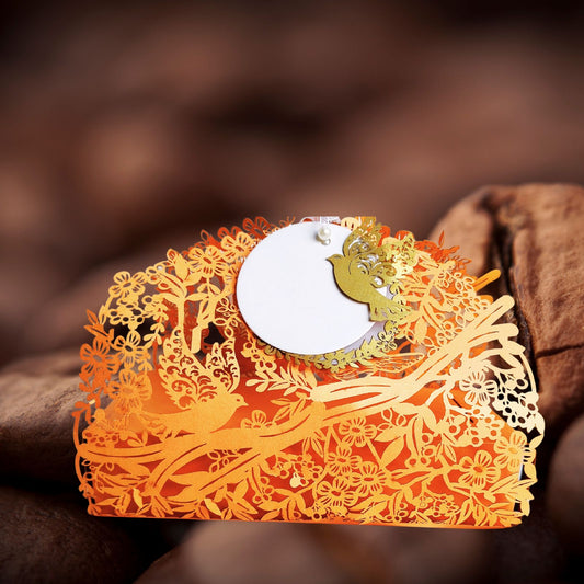 Orange full jali cashbox with intricate laser cut detailing of birds and nature, with a ribbon on top