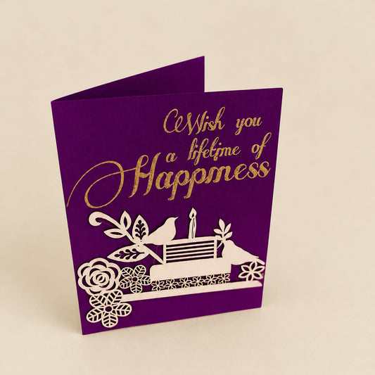 purple gift tag with intricate laser-cut detailing of birds, flowers and cake