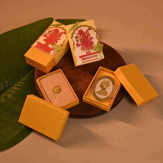 Set of decorative Envelope, coin boxes and an orange pouch with intricate designs, the theme is Pitchwai, tanjore and Srinathji