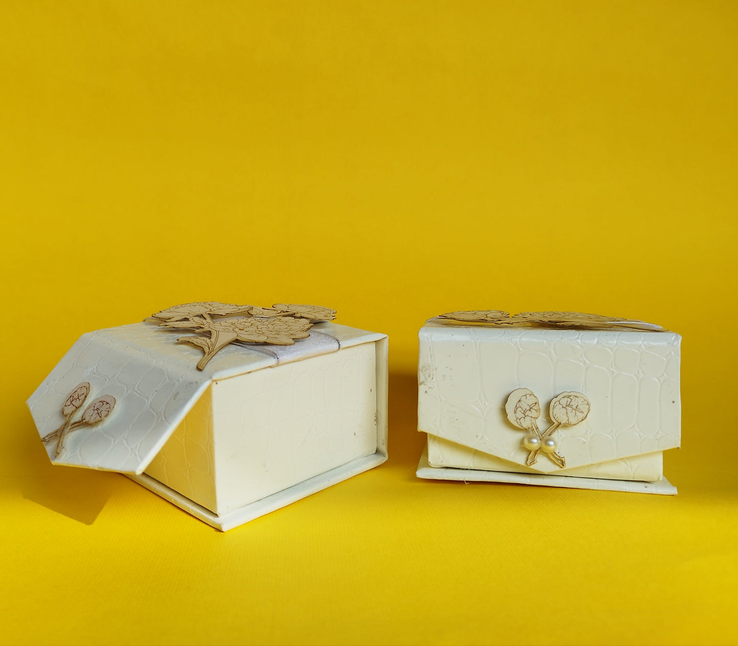 White square coin box with gold print white flower