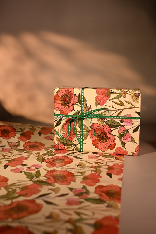 This reversible wrapping paper, having two distinct vibes—the bold, energetic orange and pink blooms on one side and the clean, white minimal design on the other—makes it such a versatile staple for a gift-wrap stash.