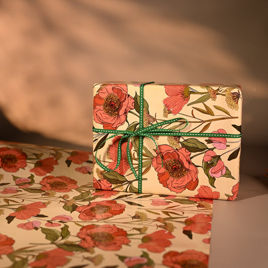 This reversible wrapping paper, having two distinct vibes—the bold, energetic orange and pink blooms on one side and the clean, white minimal design on the other—makes it such a versatile staple for a gift-wrap stash.