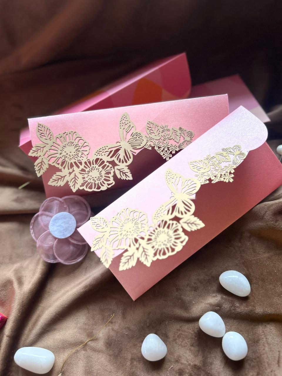 Pink flap envelopes with laser-cut butterfly design