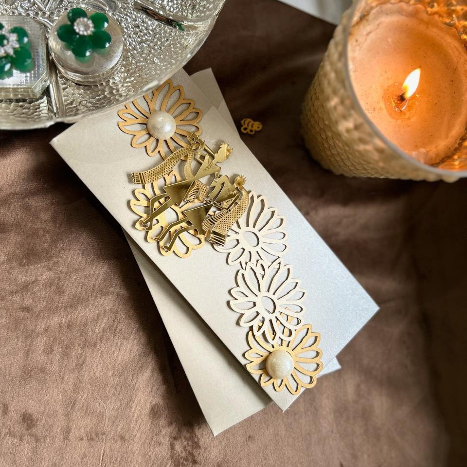 silver envelope with gold acrylic radha krishna and fowers with pearls on them