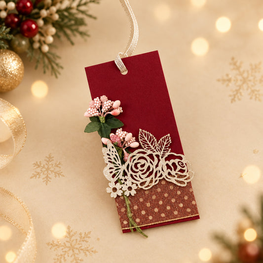 red gift tag with white ribbon and floral designs