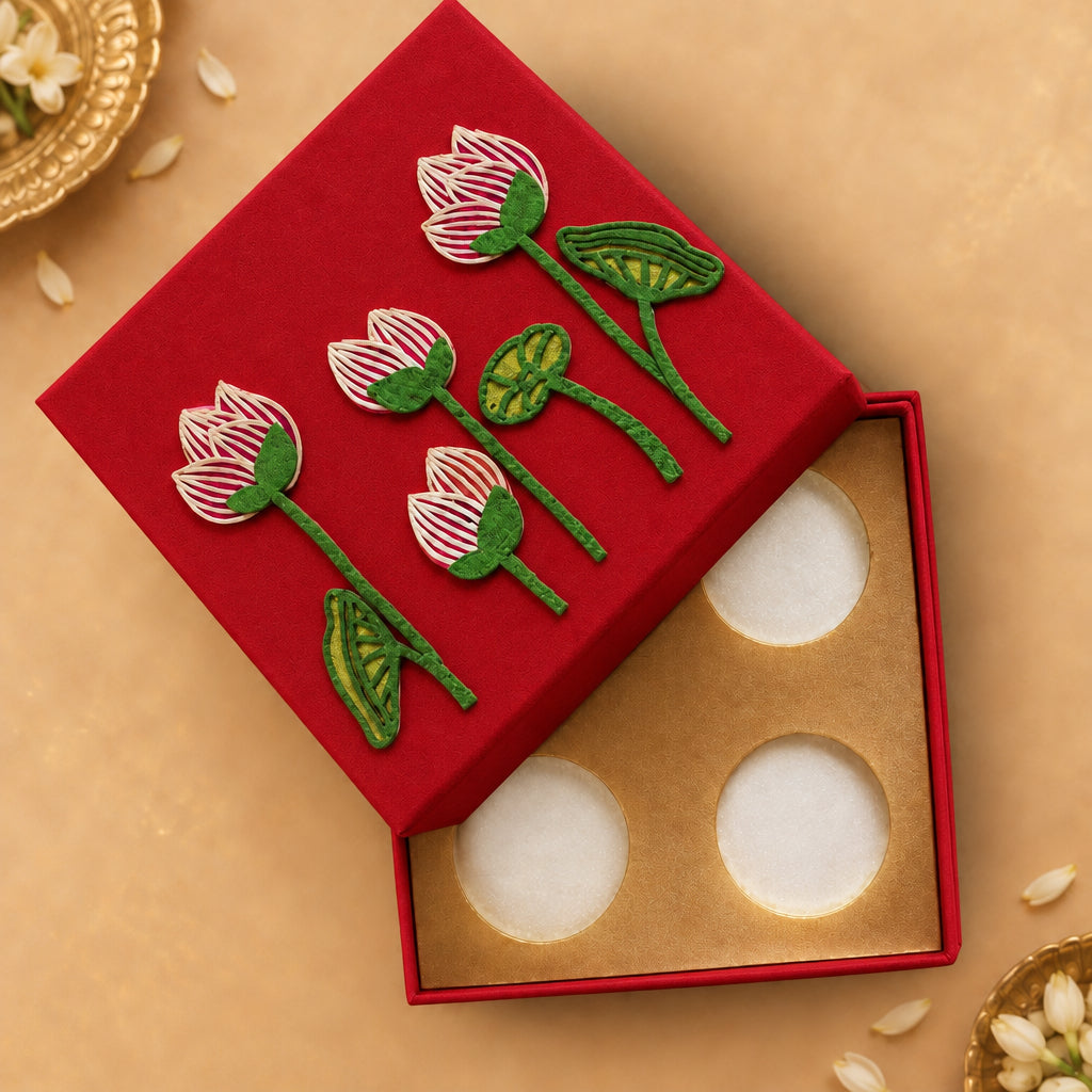 silver coin box with pichwai lotus design placed on it