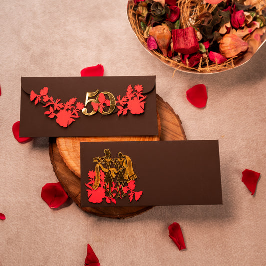Decorative envelopes with floral designs and numbers on a textured surface with red petals.