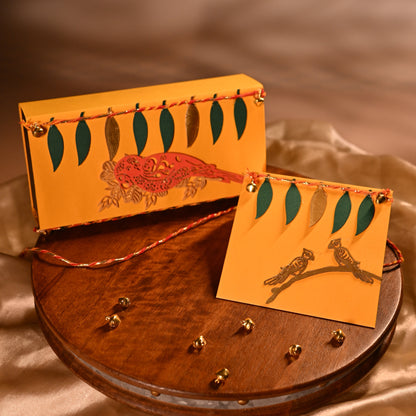 A mustard yellow Money Envelope featuring green and Golden leaf motifs and a orange parrot.