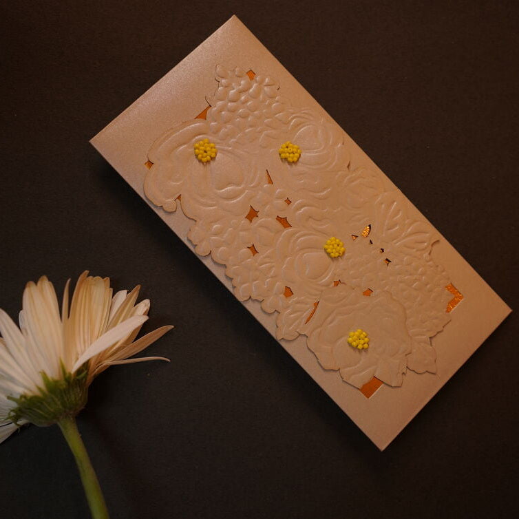 Emboosed floral pattern on an green & Silver envelope