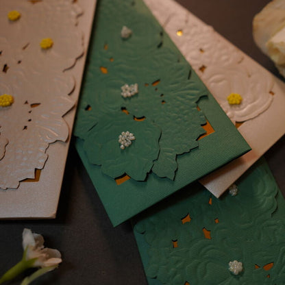 Emboosed floral pattern on an green & Silver envelope
