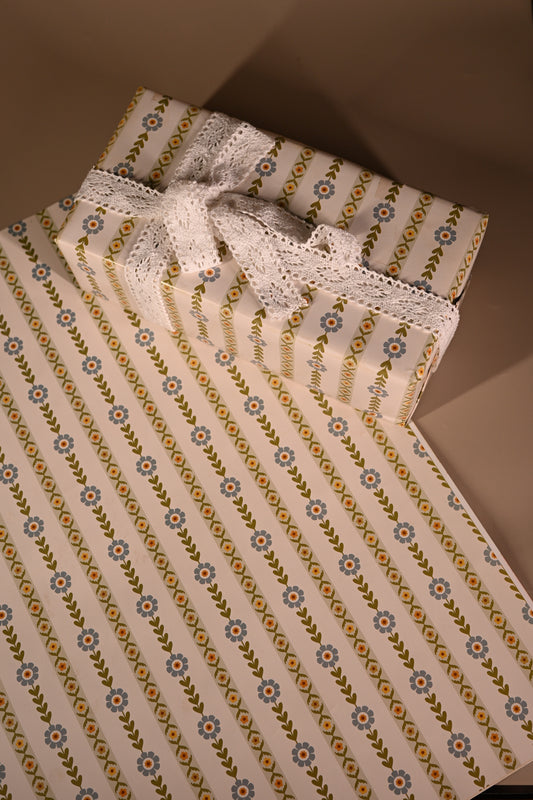 This reversible wrapping paper having two distinct vibes—the bold, energetic orange and pink blooms on one side and the clean, white minimal design on the other—makes it such a versatile staple for a gift-wrap stash.