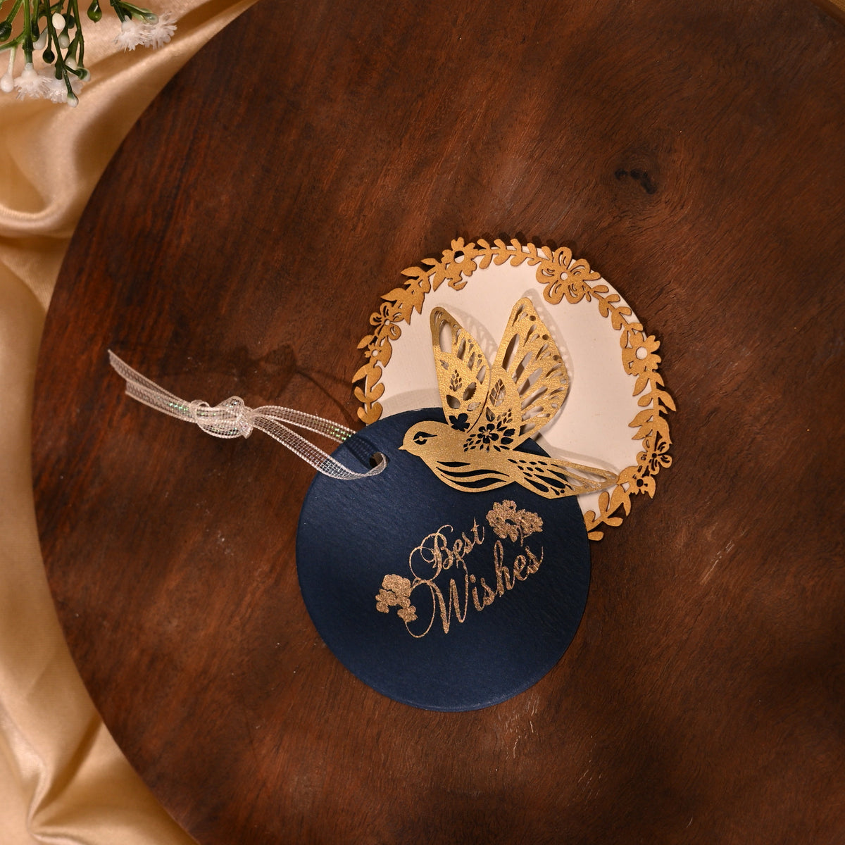 Layered blue gift tags with gold 'Best Wishes' text and gold bird cut-outs, in laser cut detailing