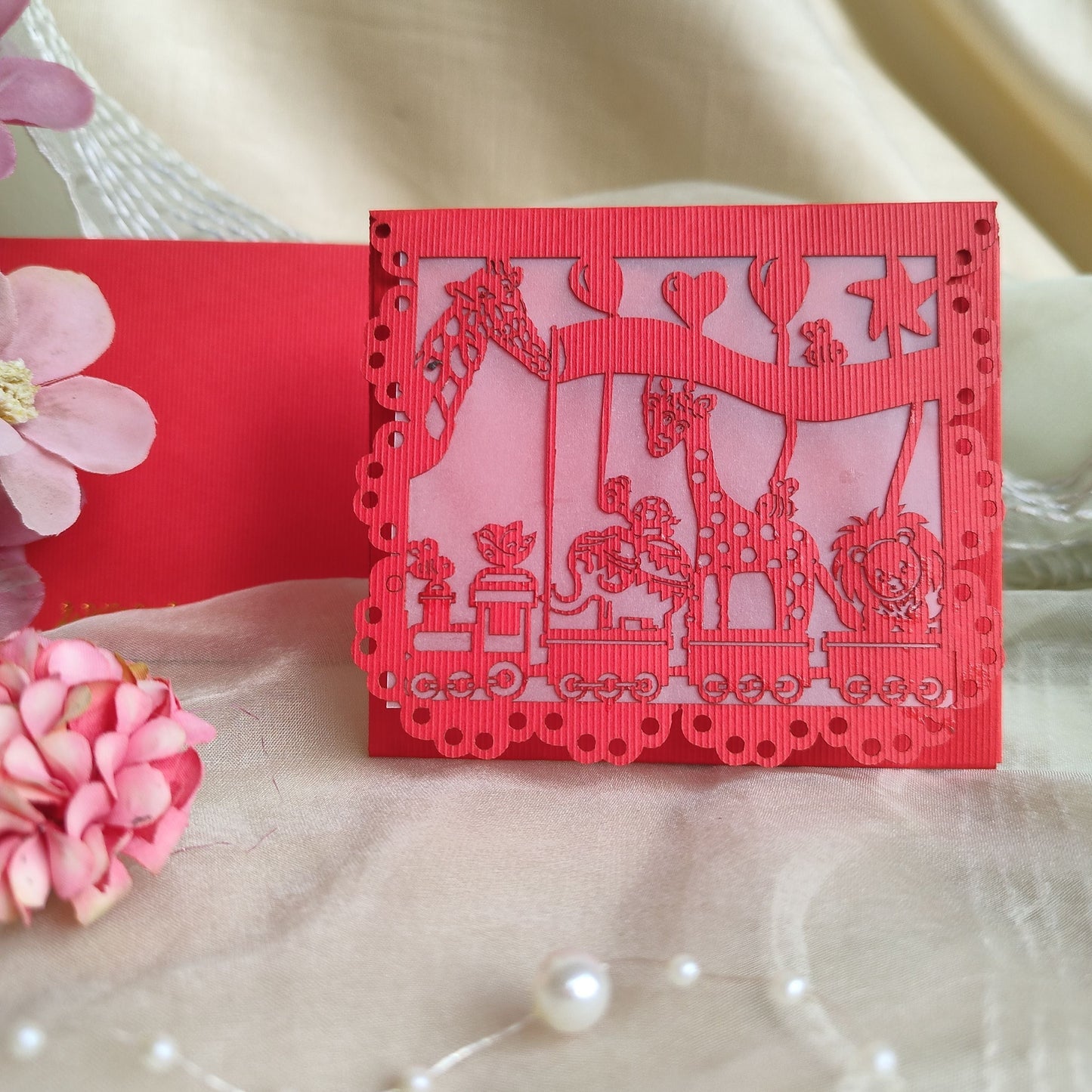 A collection of colourful laser cut envelopes with a design featuring animals