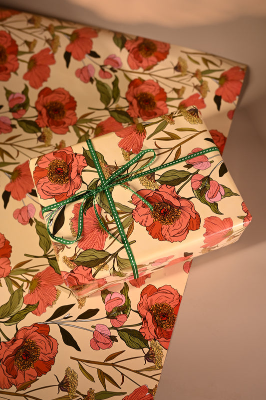 This reversible wrapping paper having two distinct vibes—the bold, energetic orange and pink blooms on one side and the clean, white minimal design on the other—makes it such a versatile staple for a gift-wrap stash.