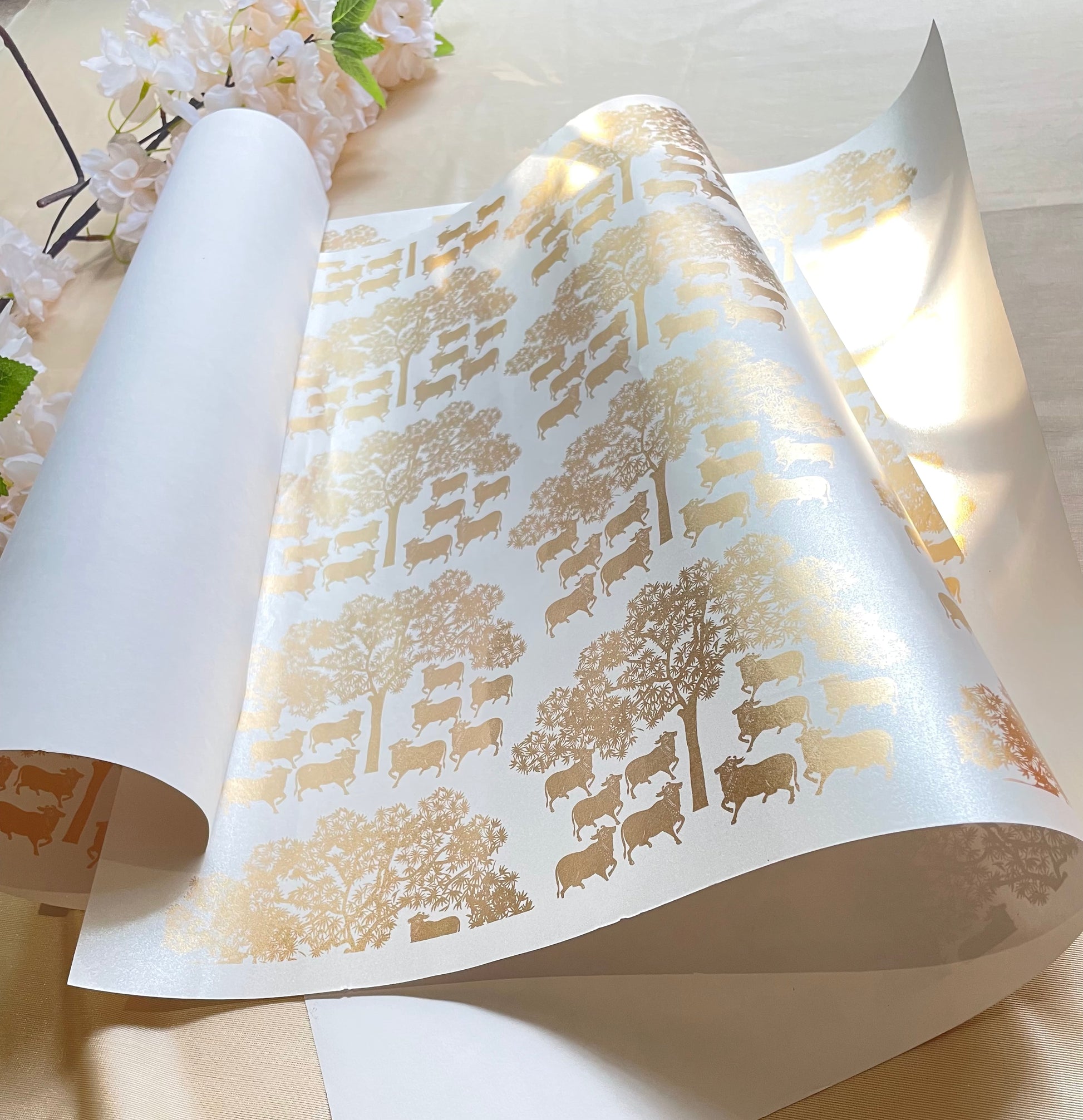 wrapping paper with a gold pichwai print design, featuring tree patterns