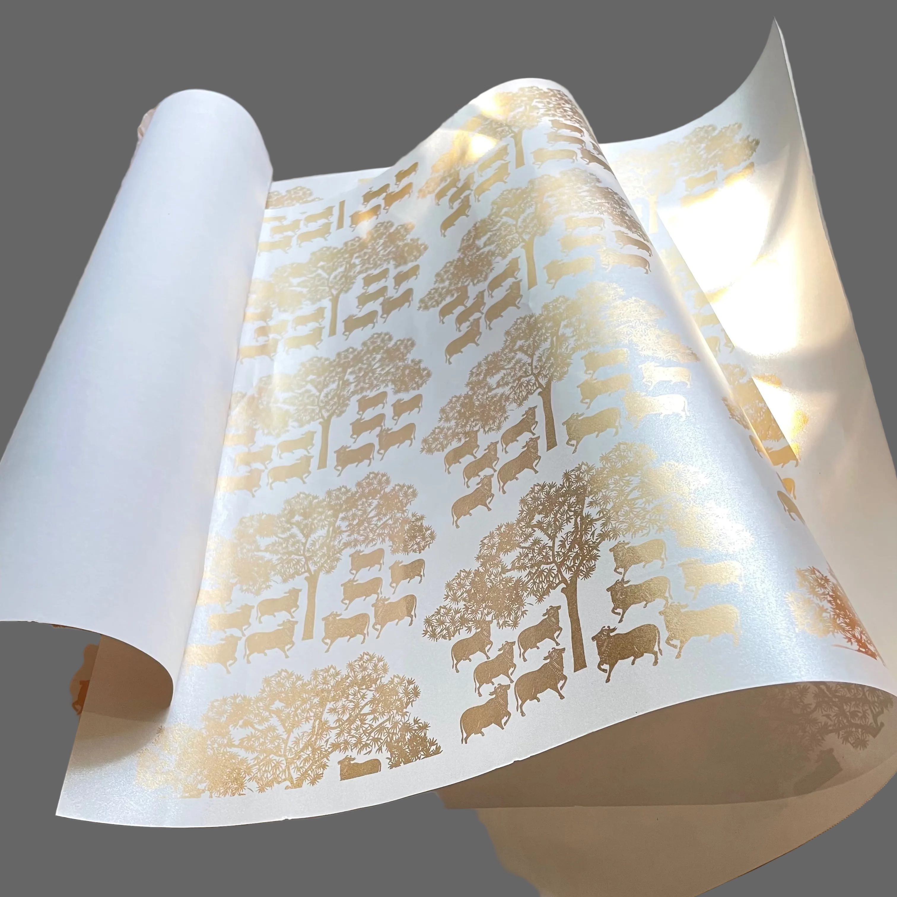 wrapping paper with a gold pichwai print design, featuring tree patterns