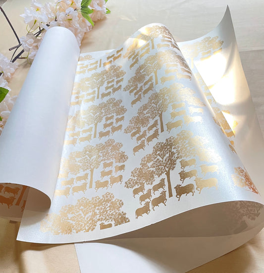 wrapping paper with a gold pichwai print design, featuring tree patterns