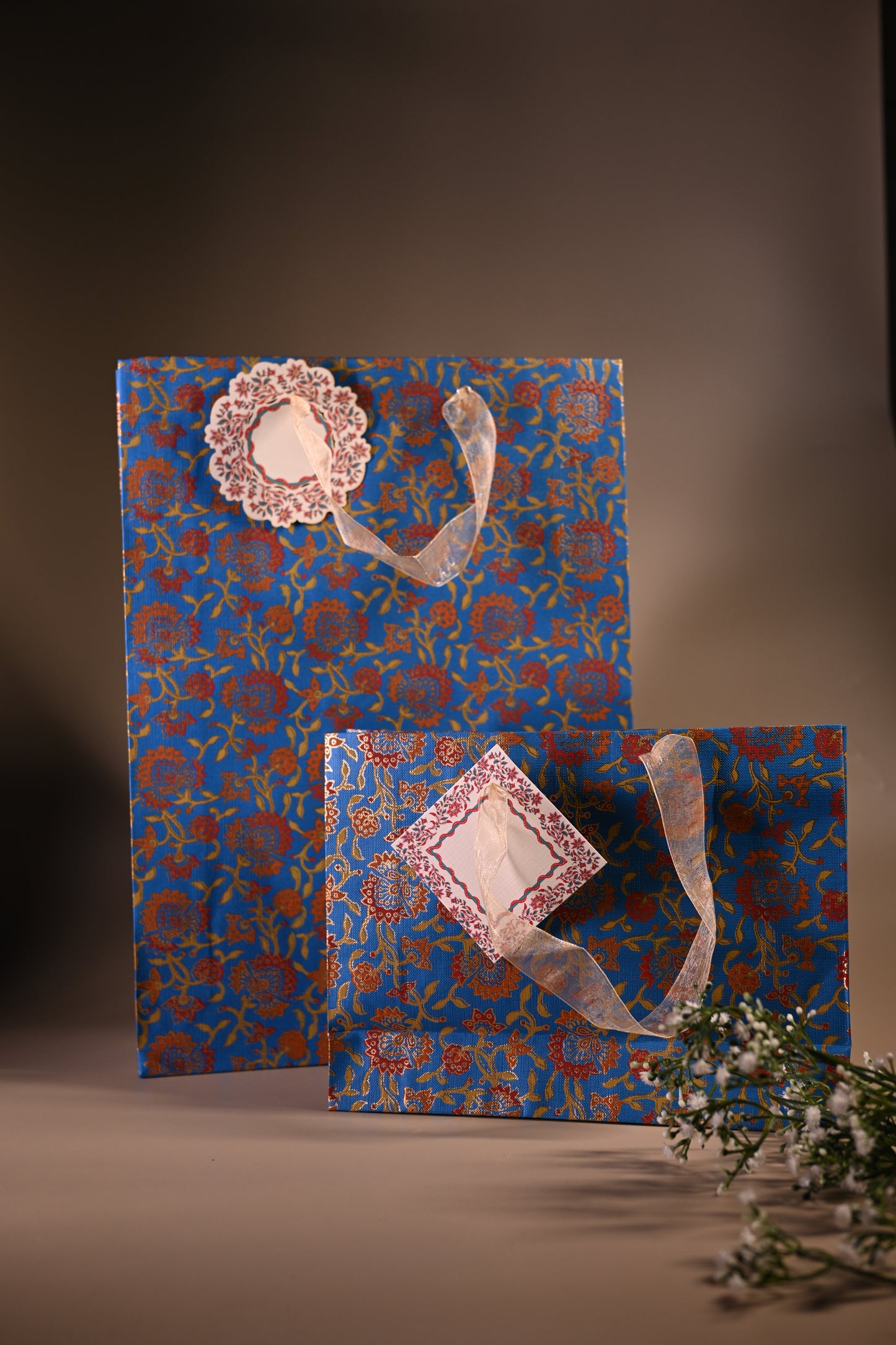 Gift bags with blue background and red floral motifs