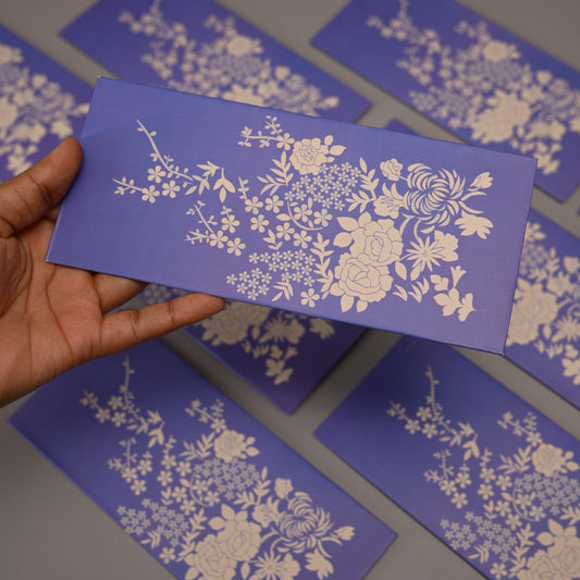Lavender Envelope with a white floral pattern.