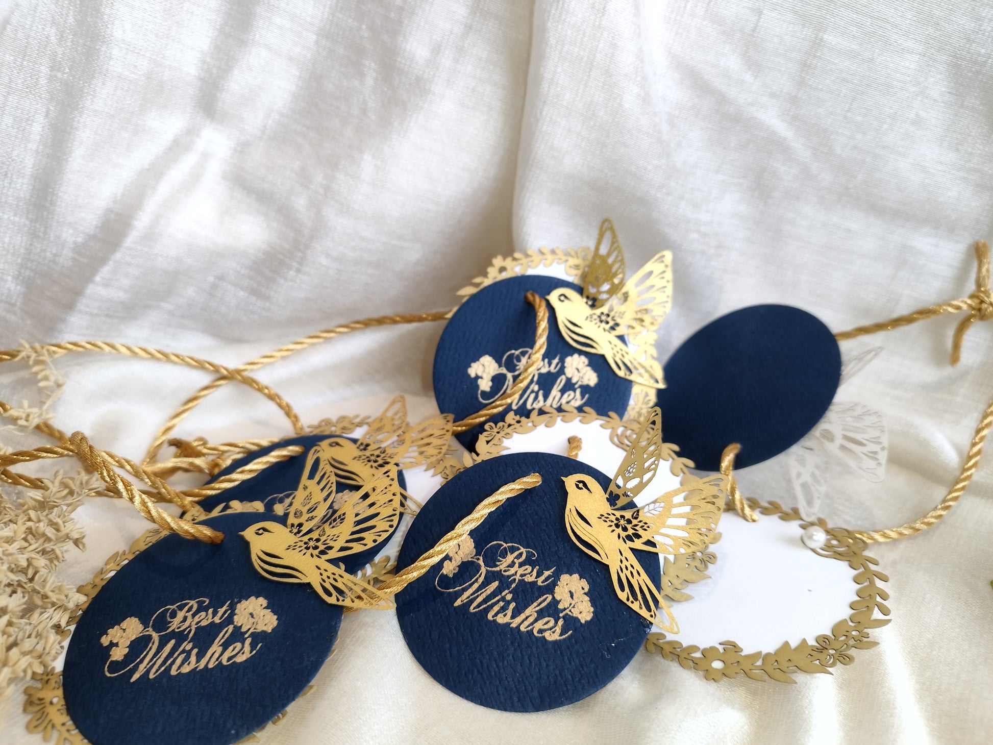 Layered blue gift tags with gold 'Best Wishes' text and gold bird cut-outs, in laser cut detailing