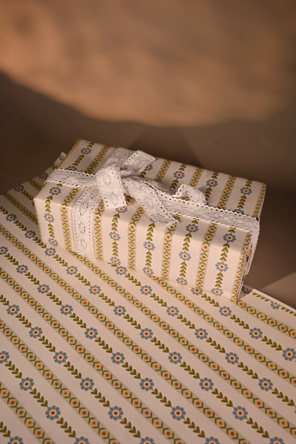 This reversible wrapping paper having two distinct vibes—the bold, energetic orange and pink blooms on one side and the clean, white minimal design on the other—makes it such a versatile staple for a gift-wrap stash.