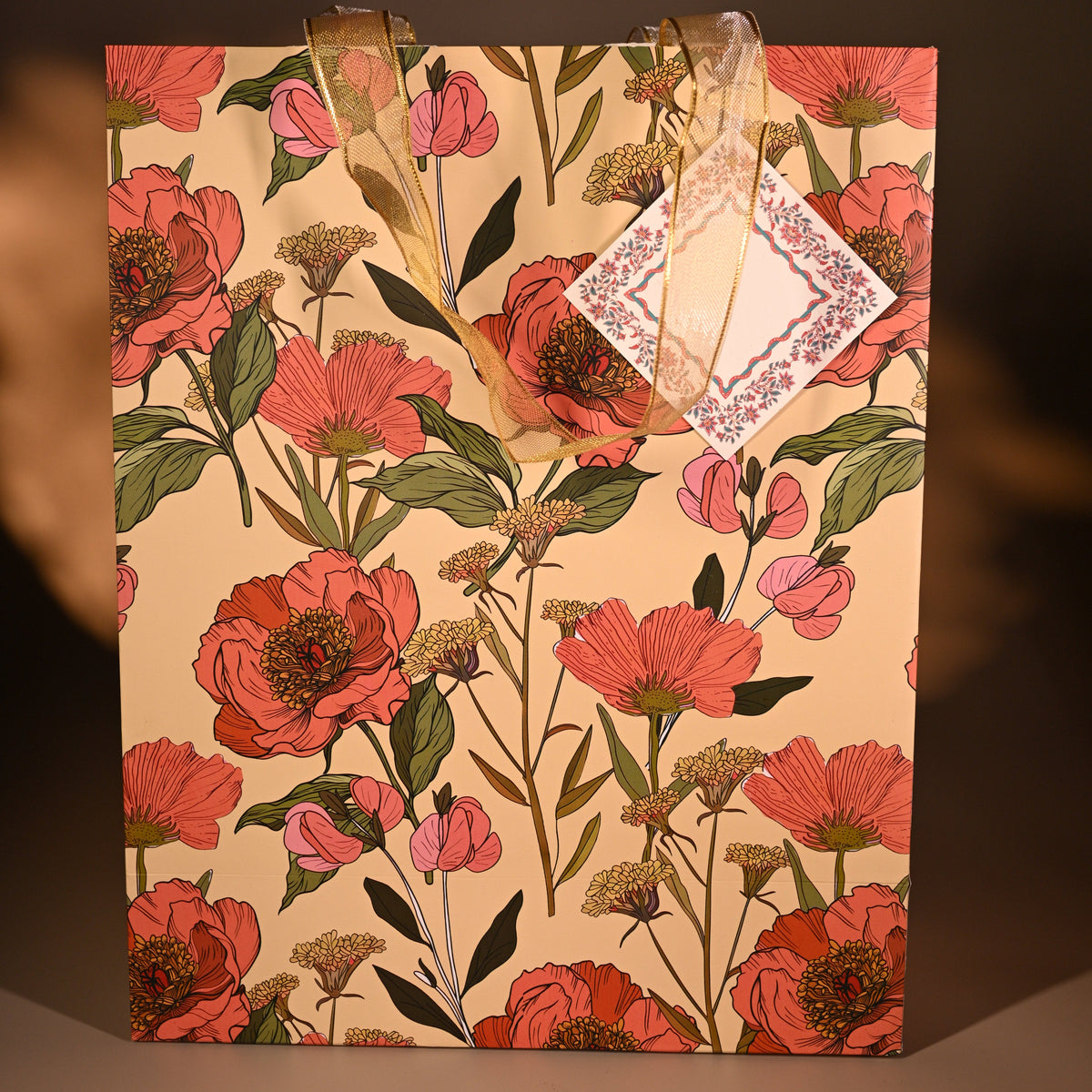 Floral-patterned bag with a card on a brown background
