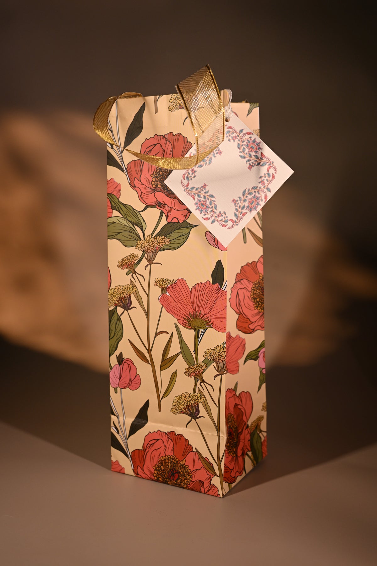 Floral-patterned box with a bow on a reflective surface