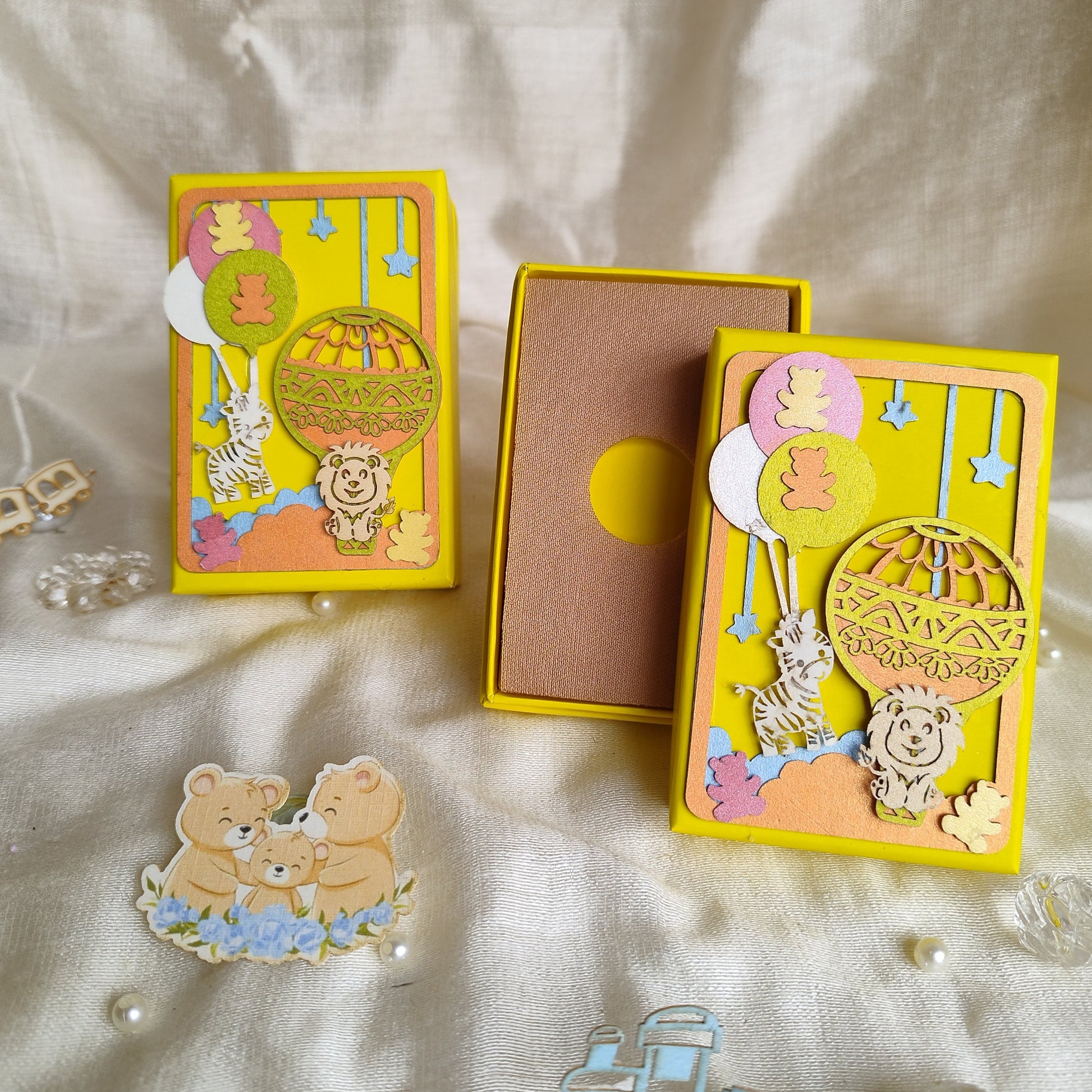 Lemon yellow coin box with animals and parachutes made with laser cutting and texture paper