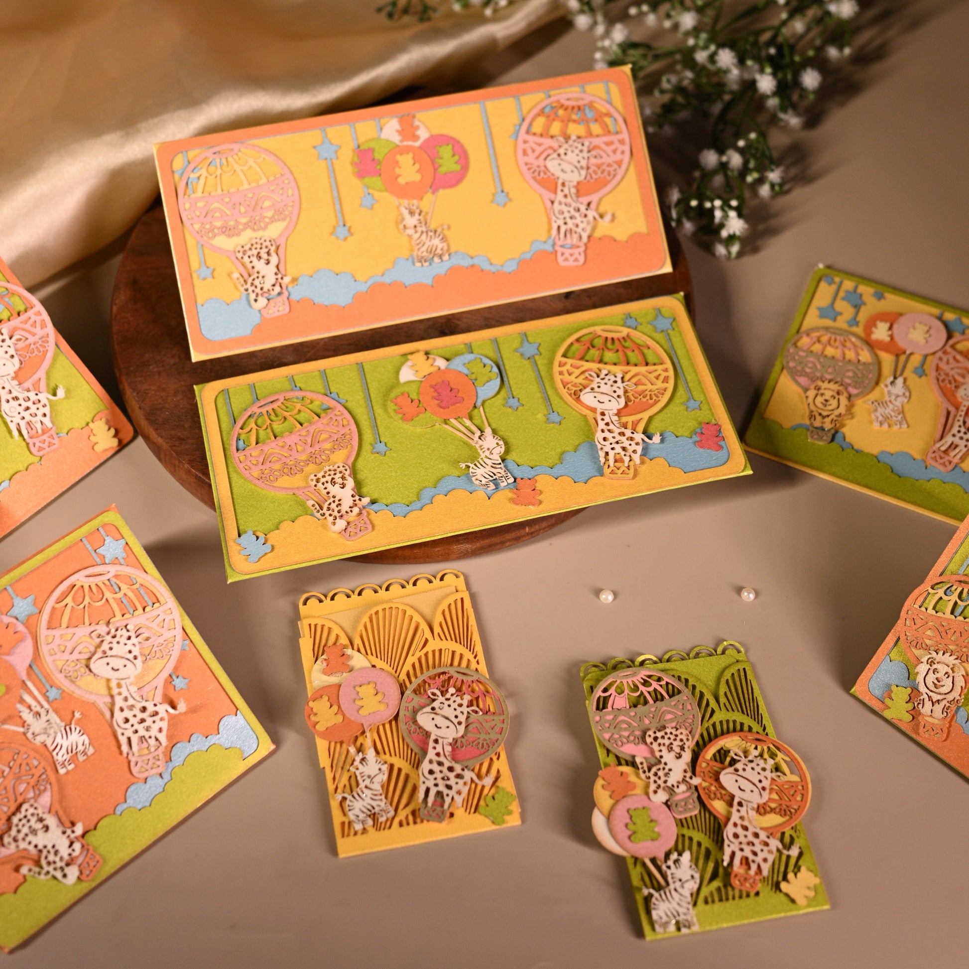 parachute  and animal envelopes on bright backgrounds and featuring intricate laser cut work.