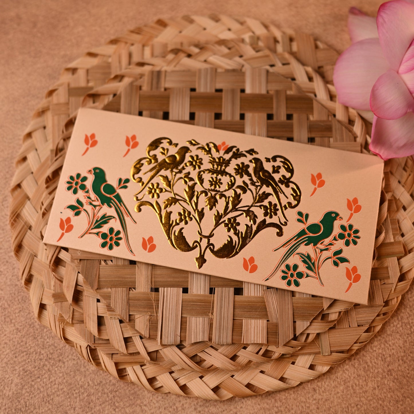 Decorative shagun envelopes with traditional gold parrot designs on a textured surface