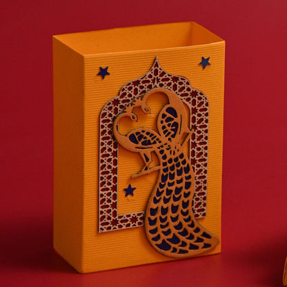 Coin Box featuring one open box with a laser-cut peacock design and stars, and two stacked closed boxes.