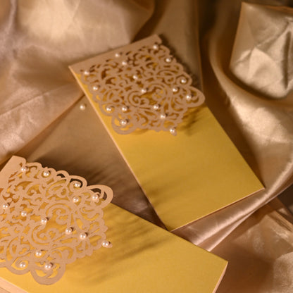 Pearl Sagun money Envelope in yellow colour with lazer cut design and pearl detailing.