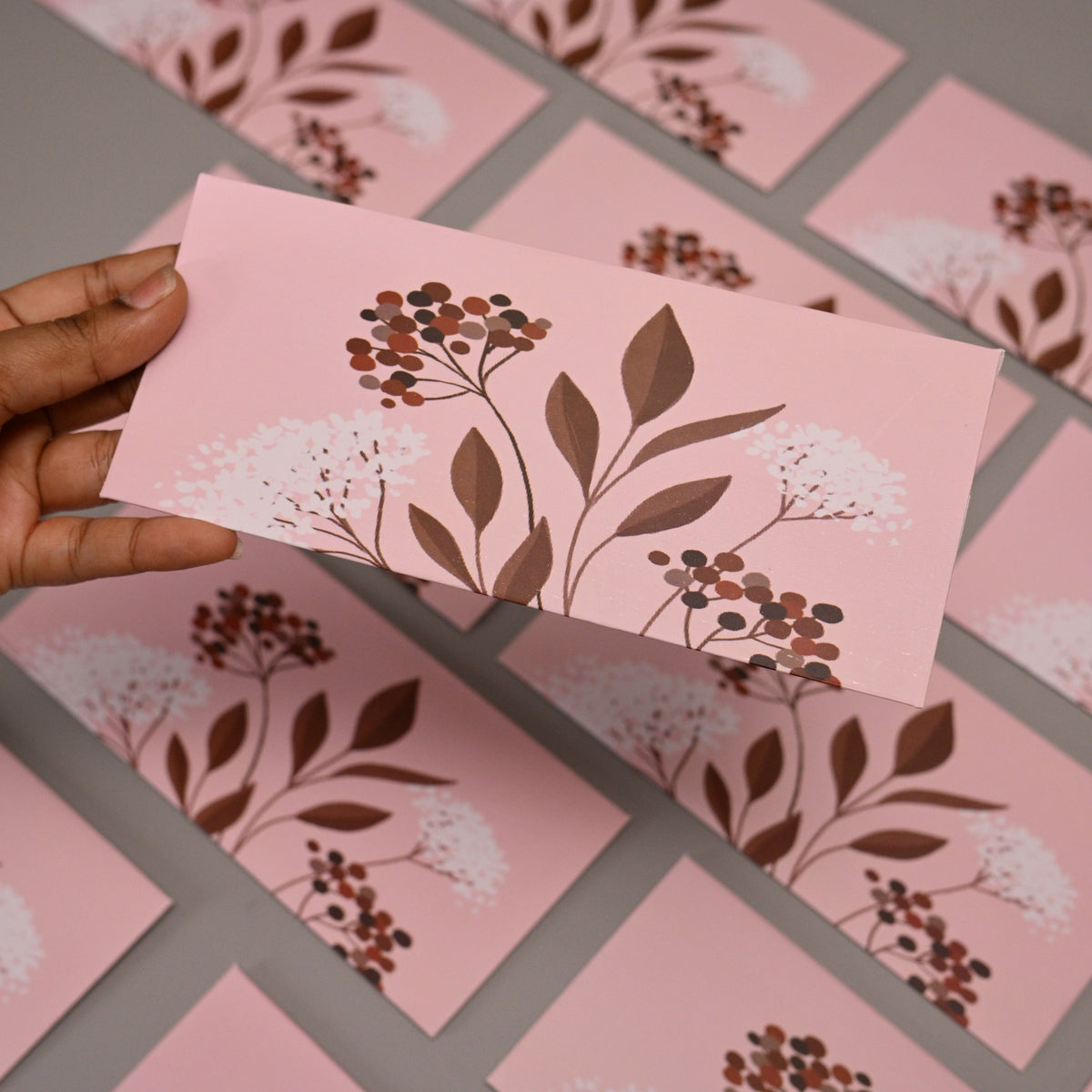envelope featuring a botanical floral print in brown and white