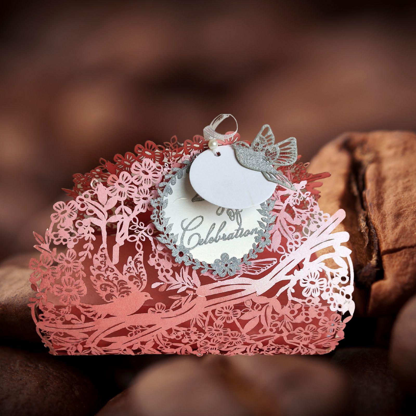 Pink full jali cashbox with intricate laser cut detailing of birds and nature, with a ribbon on top
