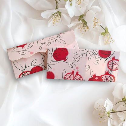 Two light envelopes with red pomegranate designs