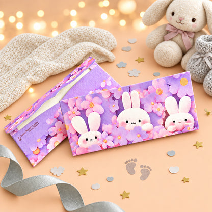 Two pink envelopes with cartoon bunny designs on texture paper