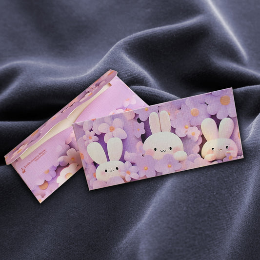 Two pink envelopes with cartoon bunny designs on texture paper