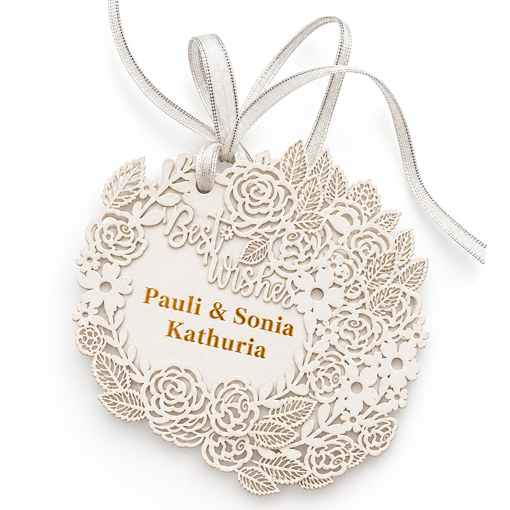 A personalized laser-cut wooden ornament with intricate floral lace patterns, hanging ribbons