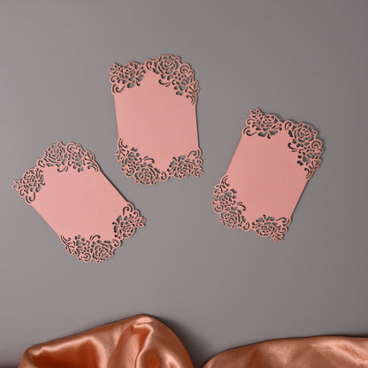 Rose rectangular cards with ornate laser-cut floral borders.