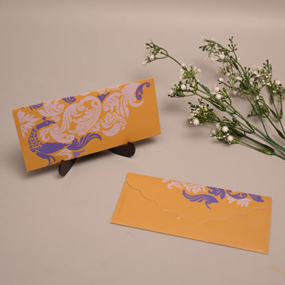 A pair of Mendhi yellow envelopes with purple and white ornate floral patterns