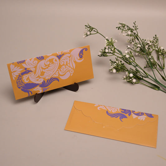 A pair of Mendhi yellow envelopes with purple and white ornate floral patterns
