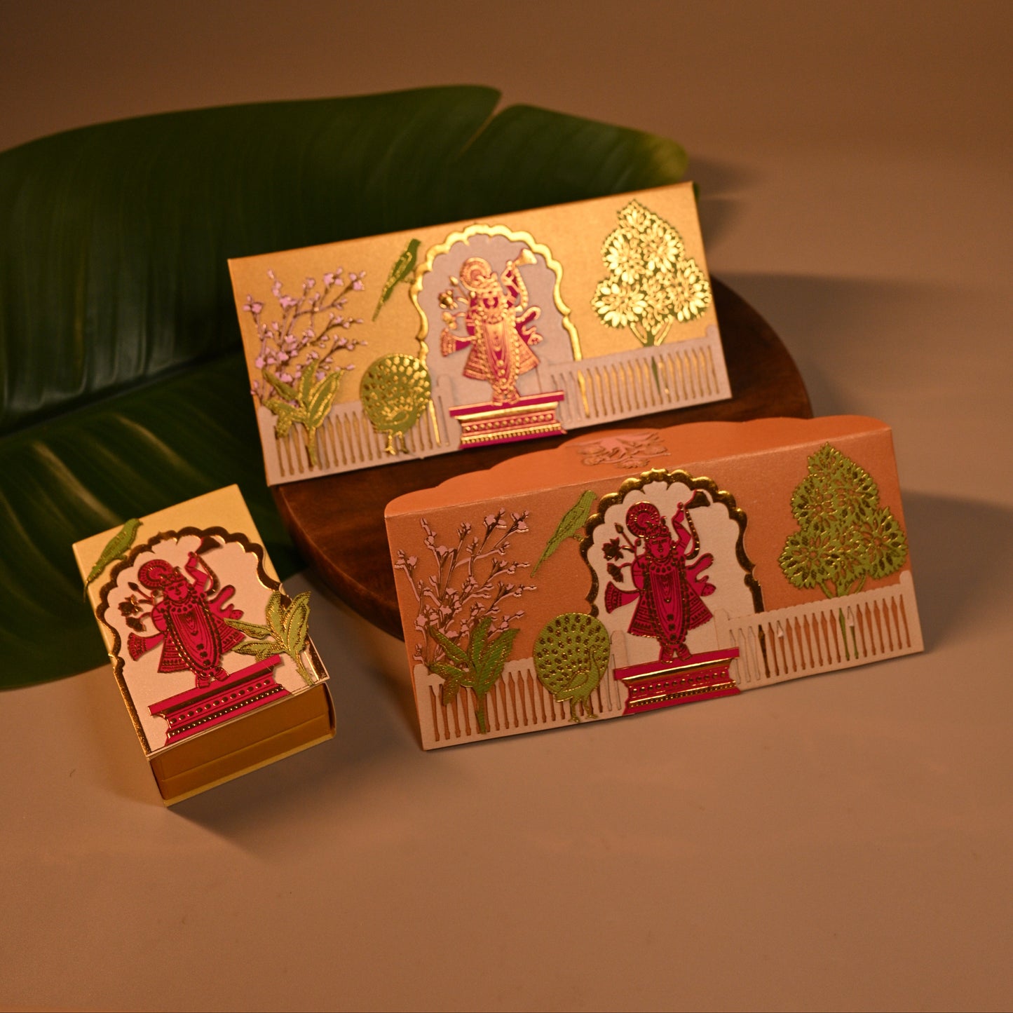 Set of decorative Envelope, coin boxes and an orange pouch with intricate designs, the theme is Pitchwai, tanjore and Srinathji