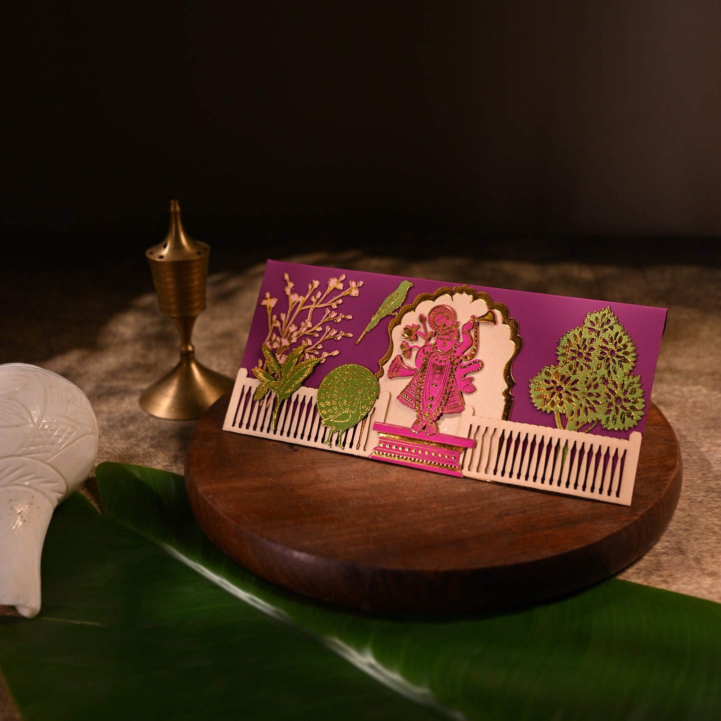 envelope featuring intricate aser cut design and shree nathji