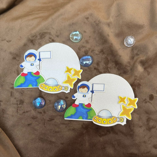 Two space gifts tags of astronauts with a UFO and stars 