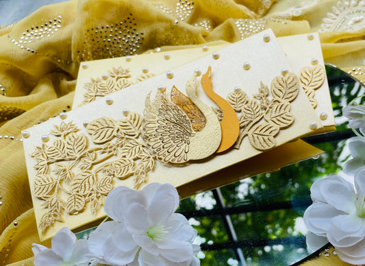 A decorative handmade Envelope featuring laser-cut swans and leaf designs.